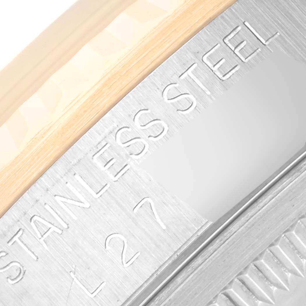 This close-up image of the Rolex Datejust 16233 Men's Steel and Gold (two tone) Champagne Dial 16233 Men's Steel and Gold (two tone) Champagne Dial watch shows the stainless steel inscribed case and the edge of the bezel.