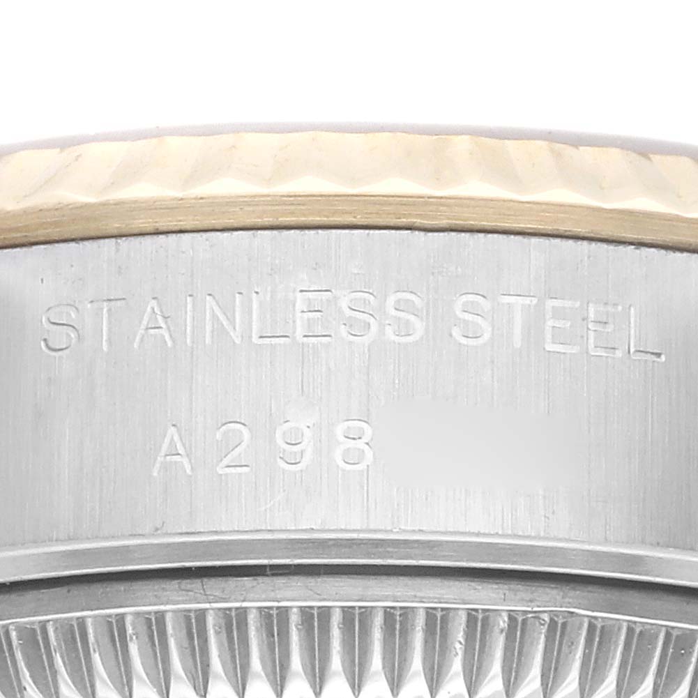 This is a close-up of a Rolex Datejust 79173G Women's Steel and Gold (two tone) Champagne Dial 79173G Women's Steel and Gold (two tone) Champagne Dial model, showing the side of the bezel and the case with "Stainless Steel" engraving.