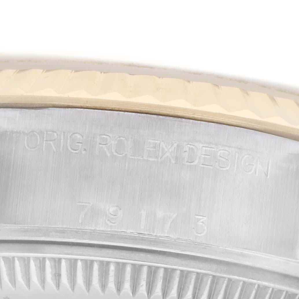 The image shows a close-up of the case side and bezel of a Rolex Datejust 79173 Women
s Steel and Gold (two tone) Champagne Dial 79173 Women
s Steel and Gold (two tone) Champagne Dial, with engravings visible.