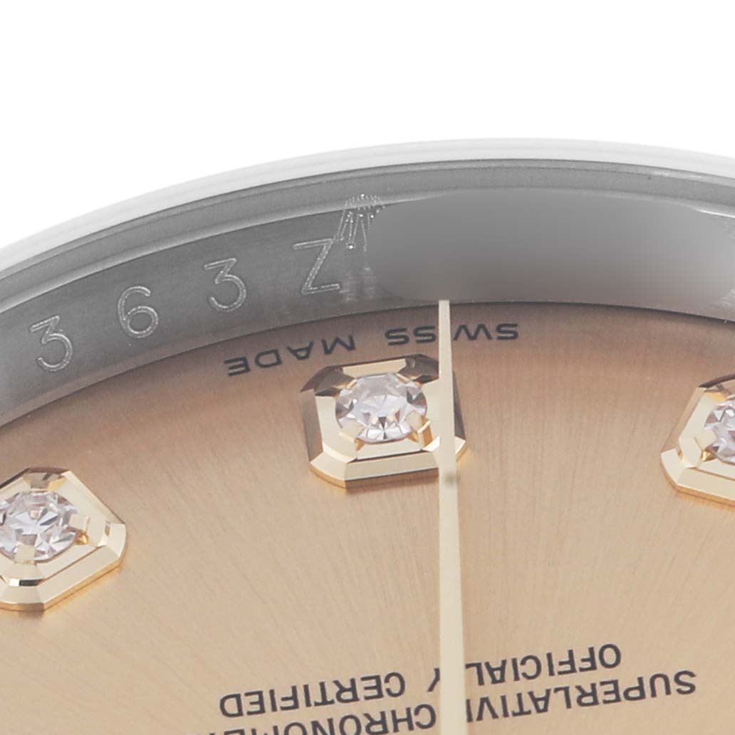 The image shows a partial angle of the Rolex Datejust 116203 Men
s Steel and Gold (two tone) Champagne Dial 116203 Men
s Steel and Gold (two tone) Champagne Dial watch, focusing on the dial with diamond hour markers and "Swiss Made" text.