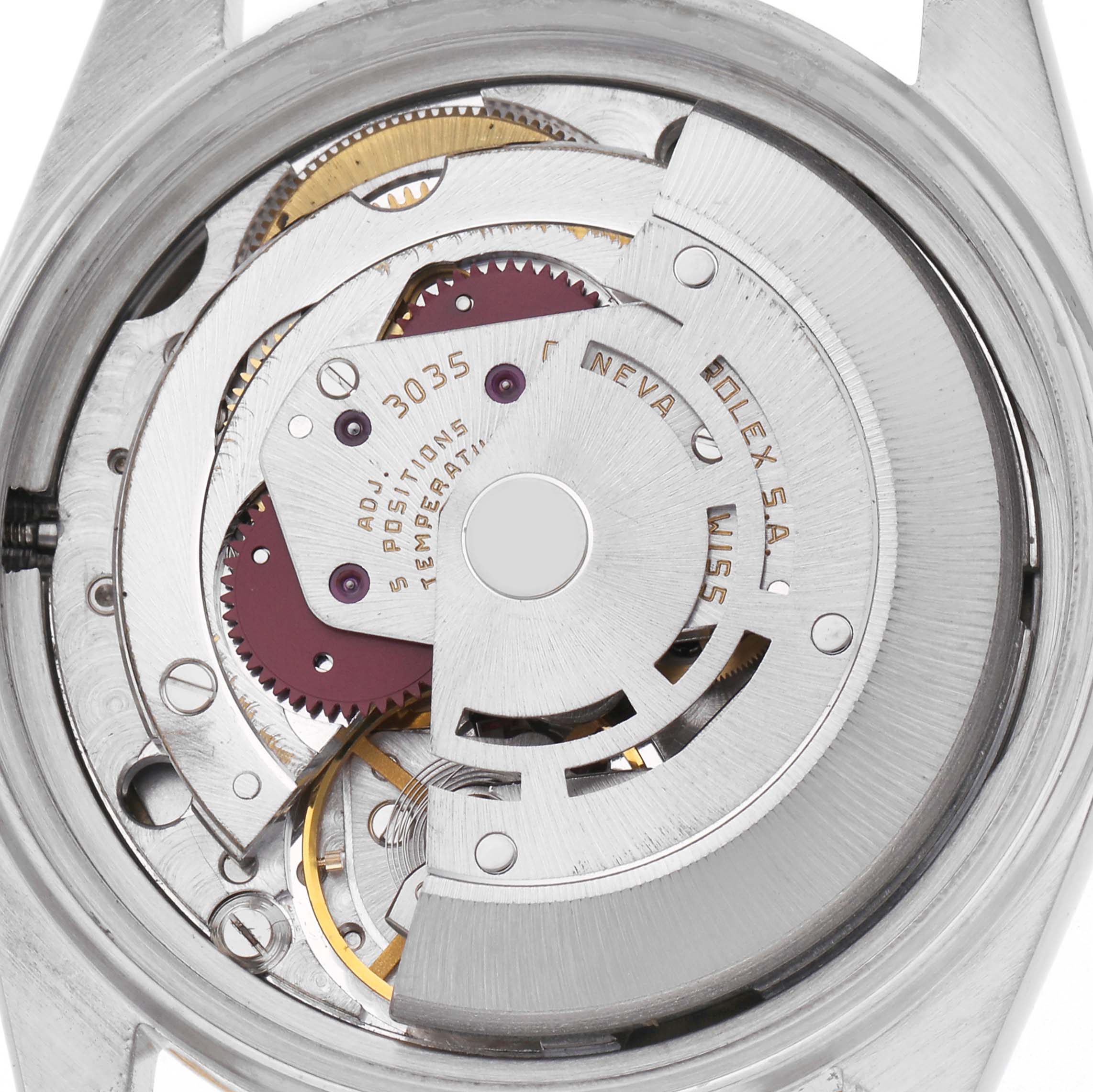The Vintage Collection Rolex model is shown from the back, revealing its intricate movement and inner gears.