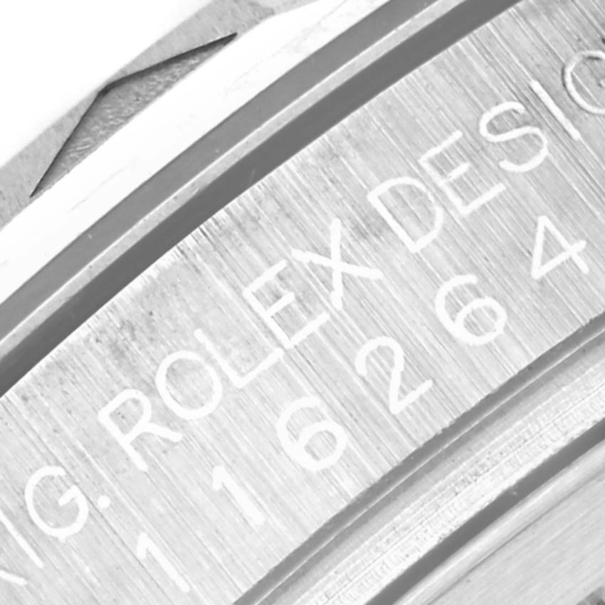 This close-up image of the Rolex Turn-o-Graph 116264 Men's Stainless Steel Black Dial 116264 Men's Stainless Steel Black Dial watch shows part of the engraved model number and brand name on the inner bezel.