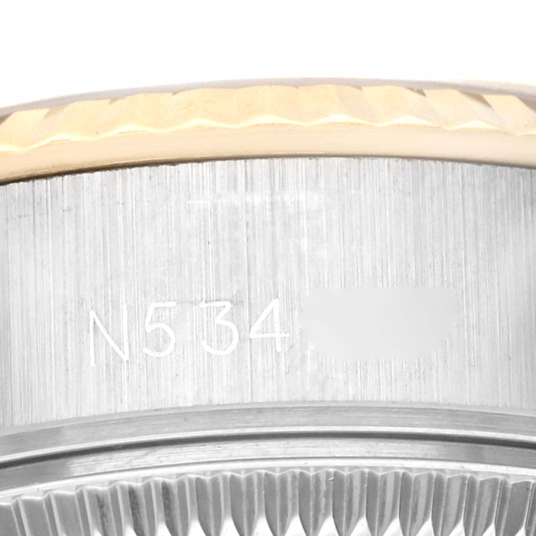 This close-up angle shows the serial number and part of the bezel of the Rolex Datejust 69173 Women's Steel and Gold (two tone) White Dial 69173 Women's Steel and Gold (two tone) White Dial model.