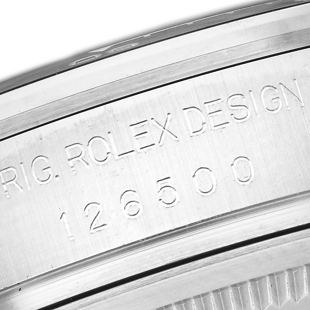 The image shows the engraved side of the bezel on a Rolex Daytona 126500 Men
s Stainless Steel White Dial 126500 Men
s Stainless Steel White Dial watch with the model number 126500.