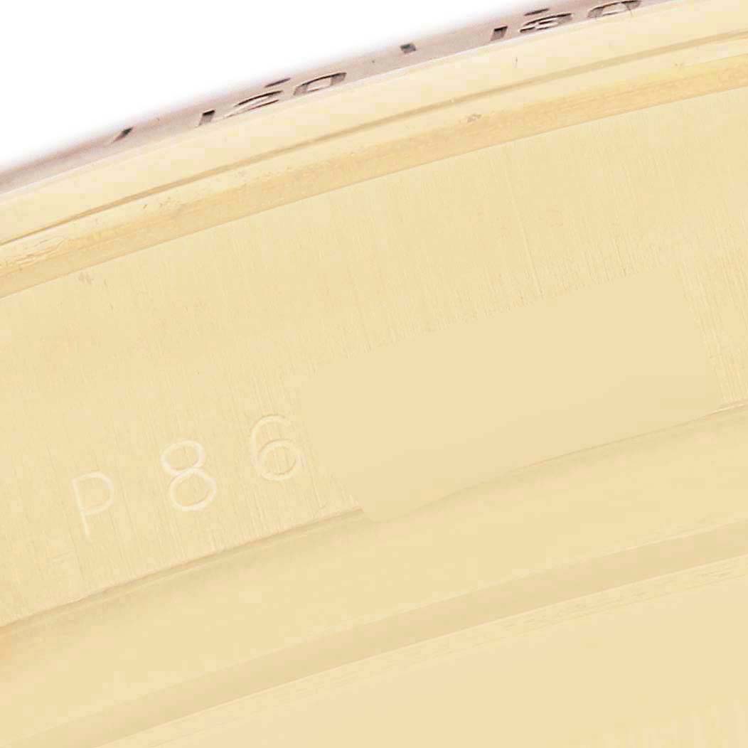 The image shows a close-up of the engraved serial number on the case of a Rolex Daytona 116528 Men
s Yellow Gold White Dial 116528 Men
s Yellow Gold White Dial watch.