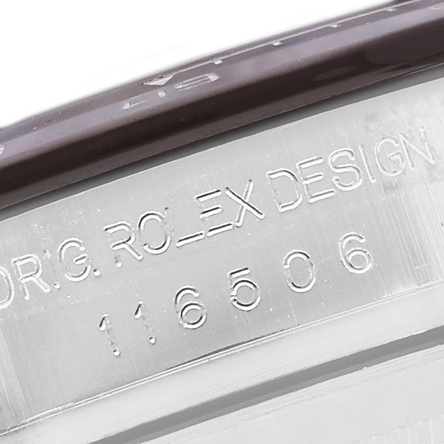 The image shows a close-up angle of the engraved serial number and text on the case side of a Rolex Daytona 116506 Men's Platinum Blue Dial 116506 Men's Platinum Blue Dial watch.