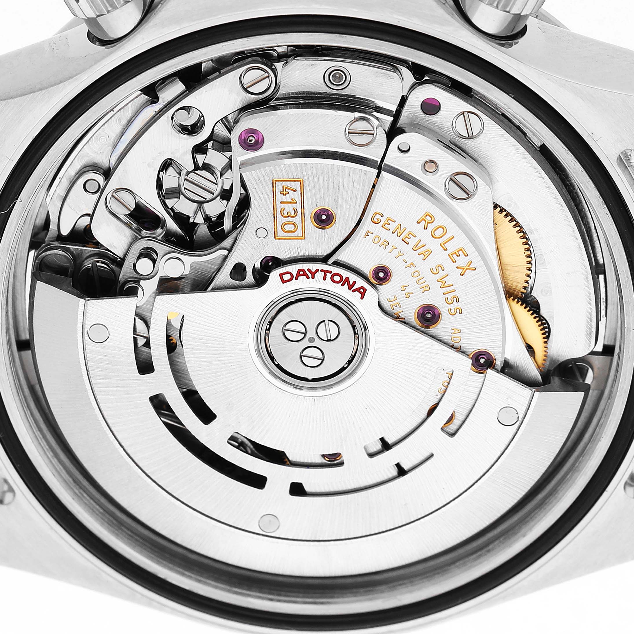 The image shows the movement of a Rolex Daytona 116520 Men's Stainless Steel White Dial watch viewed from the back, highlighting the intricate mechanical components.