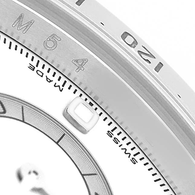 The image shows a close-up of the bezel and partial dial of a Rolex Daytona 116520 Men's Stainless Steel White Dial watch, highlighting numerals and markings.