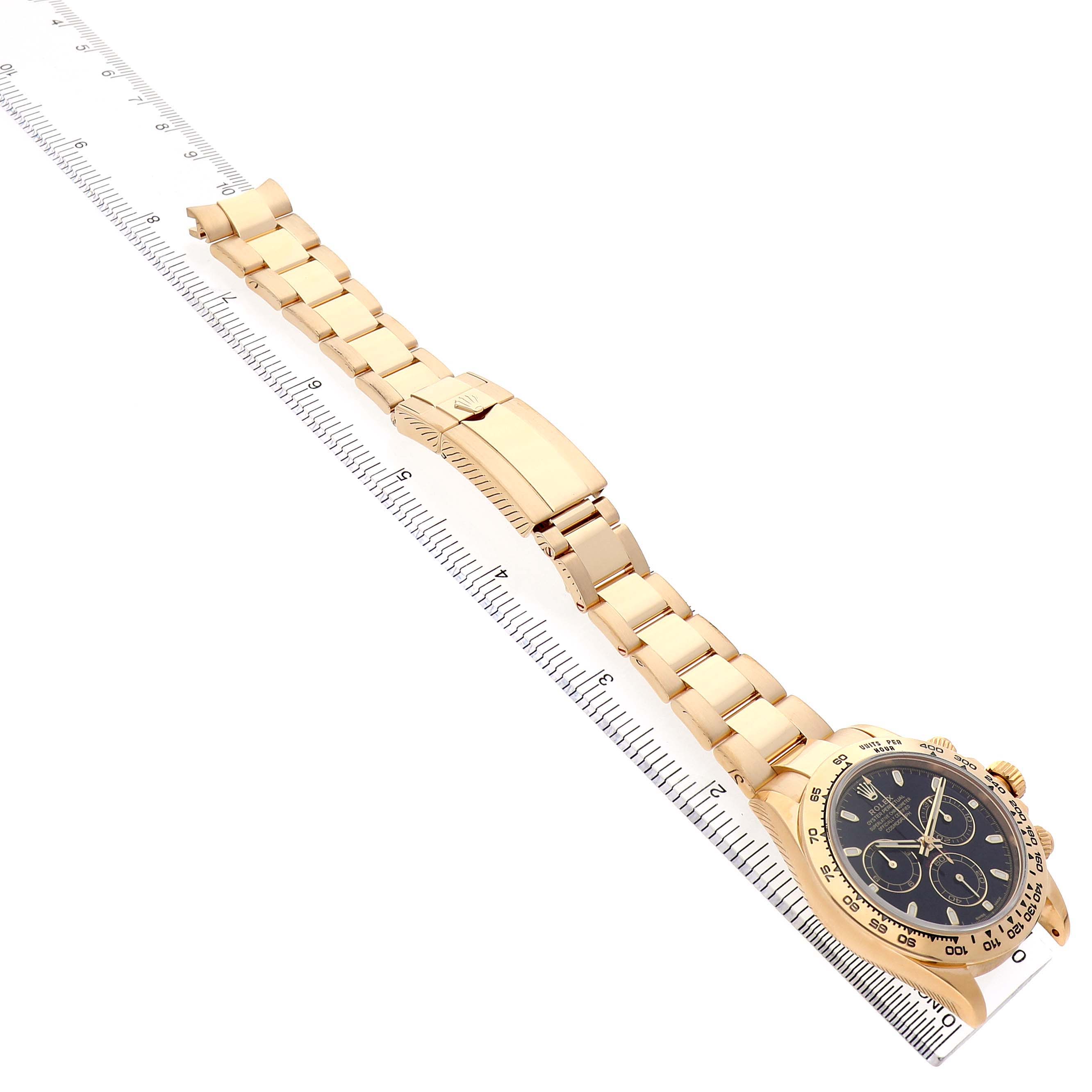 The Rolex Daytona 116508 Men's Yellow Gold Black Dial watch is shown at an angled top view, displaying the bracelet, clasp, and part of the bezel.