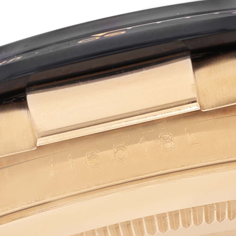 The image shows a close-up of the case and serial number engraving on a Rolex Daytona 116518 Men's Yellow Gold Black Dial 116518 Men's Yellow Gold Black Dial watch.