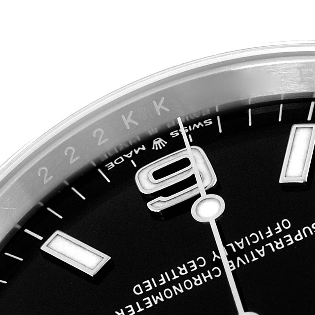 The image shows a close-up of the Rolex Explorer 124270 Men
s Stainless Steel Black Dial 124270 Men
s Stainless Steel Black Dial watch dial, focusing on the number "9," markers, and part of the bezel.