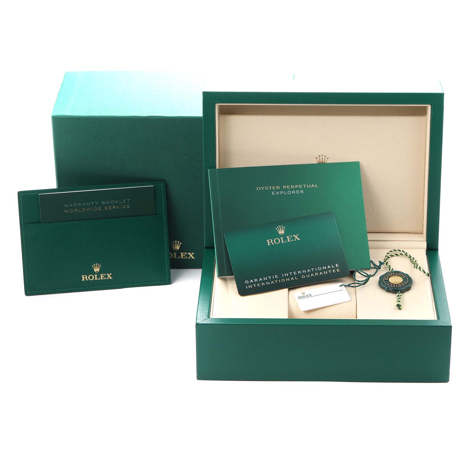 The image shows a Rolex Explorer 124270 Men
s Stainless Steel Black Dial 124270 Men
s Stainless Steel Black Dial box set with warranty booklets, guarantee card, and a green hang tag.