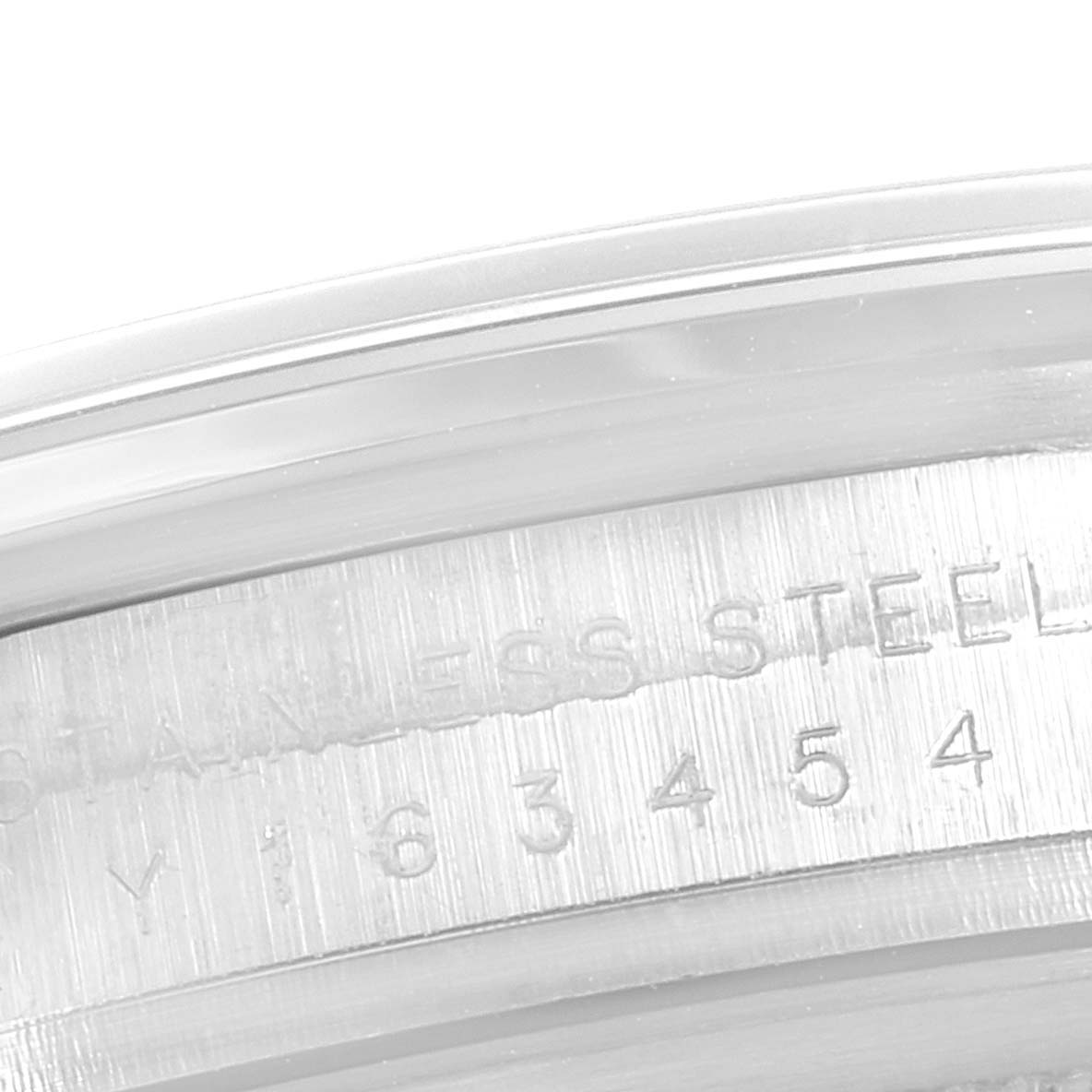 The image shows a close-up of the engraved serial number on the stainless steel case of a Rolex Explorer 114270 Men
s Stainless Steel Black Dial 114270 Men
s Stainless Steel Black Dial watch.