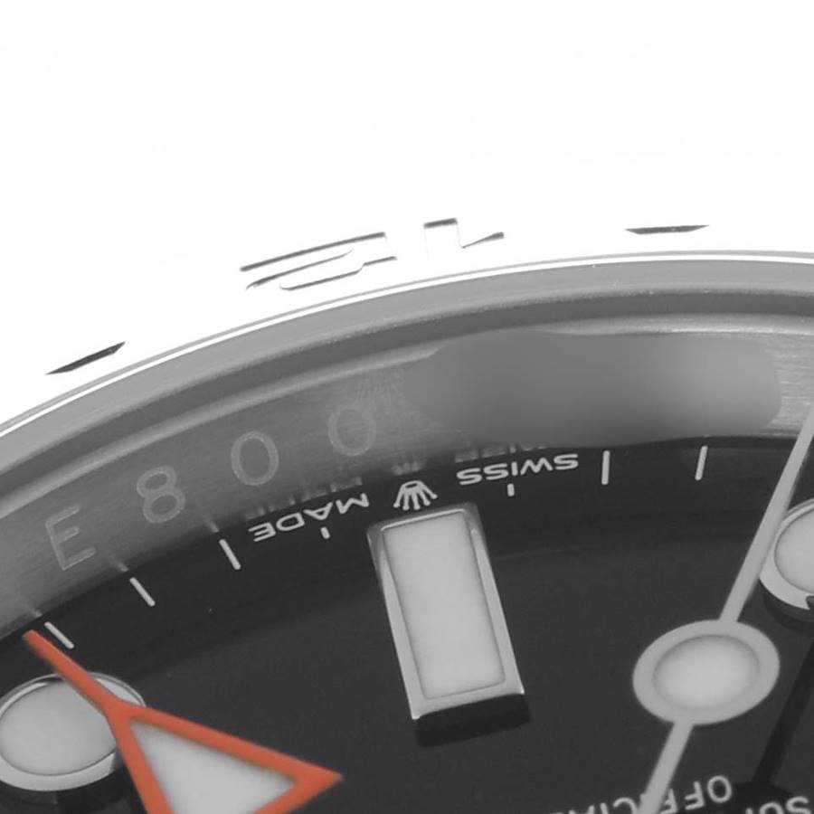 The image shows a close-up of the Rolex Explorer 226570 Men's Stainless Steel Black Dial 226570 Men's Stainless Steel Black Dial's dial and bezel edge, highlighting the hands and details like "Swiss Made."