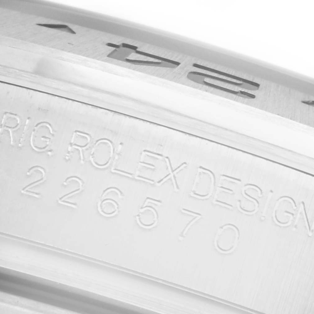 The image shows the engraved side of the Rolex Explorer 226570 Men
s Stainless Steel Black Dial 226570 Men
s Stainless Steel Black Dial watch
s case with "ROLEX DESIGN" and the model number visible.