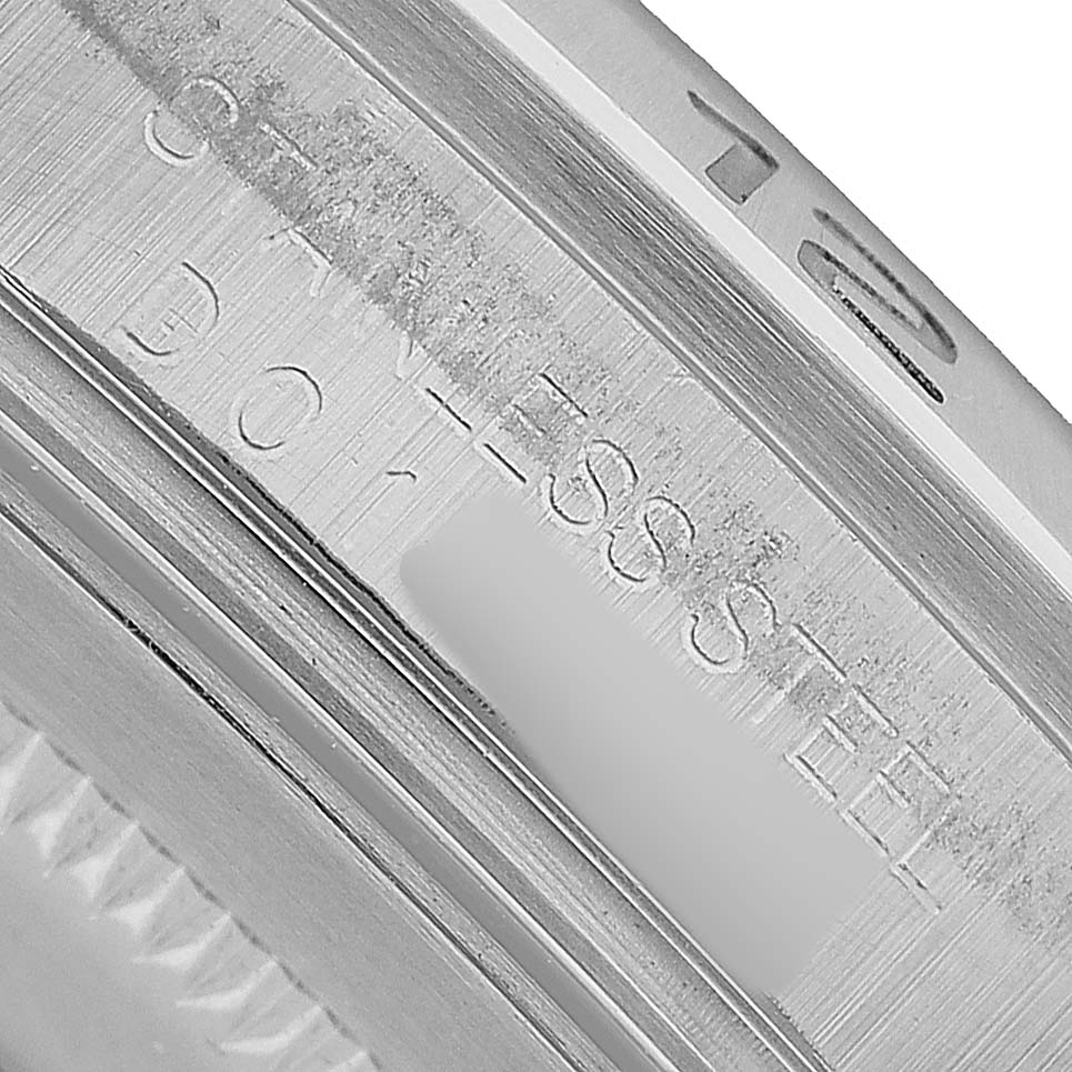 The image shows a close-up of the stainless steel case side of a Rolex Explorer 16570 Men's Stainless Steel Black Dial watch.