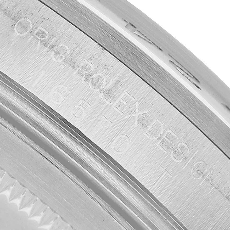 The image shows a close-up of the case engraving on the Rolex Explorer 16570 Men's Stainless Steel Black Dial, highlighting the "ORIG ROLEX DESIGN" and model number.