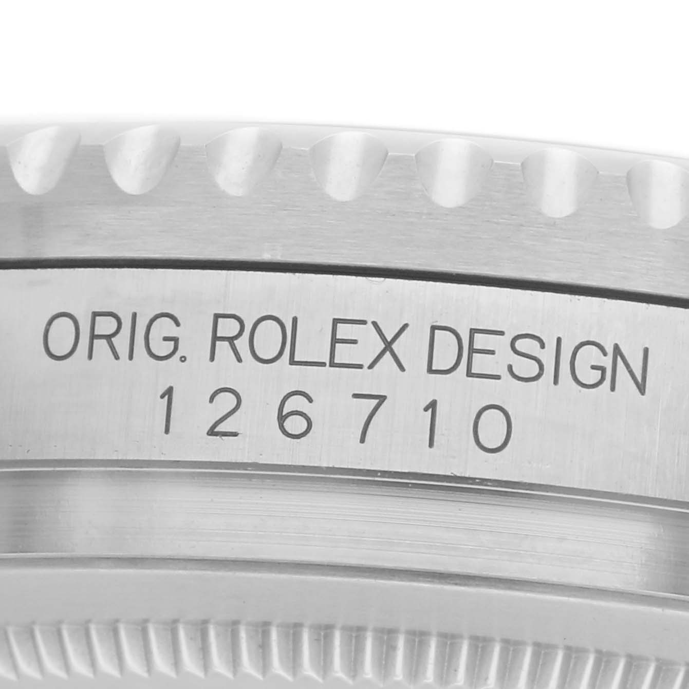 The image shows a close-up of the side of a Rolex GMT-Master 126710 Men
s Stainless Steel Black Dial 126710 Men
s Stainless Steel Black Dial, highlighting the model number 126710 and bezel edge.
