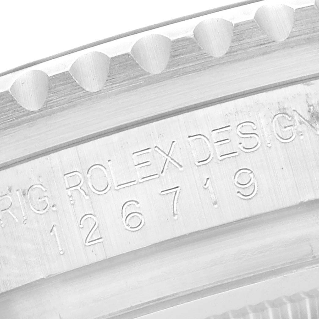 The image shows a close-up of the engraved details on the case of a Rolex GMT-Master 126719 Men
s White Gold Blue Dial 126719 Men
s White Gold Blue Dial.