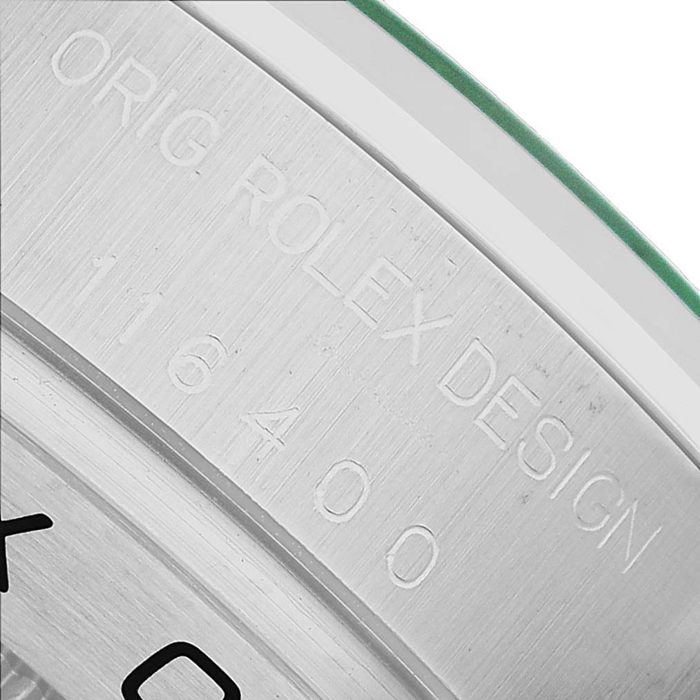 The image shows an angled close-up of the Rolex Milgauss M116400GV Men's Stainless Steel Blue Dial model's engraved casing with model number 116400 and brand markings.