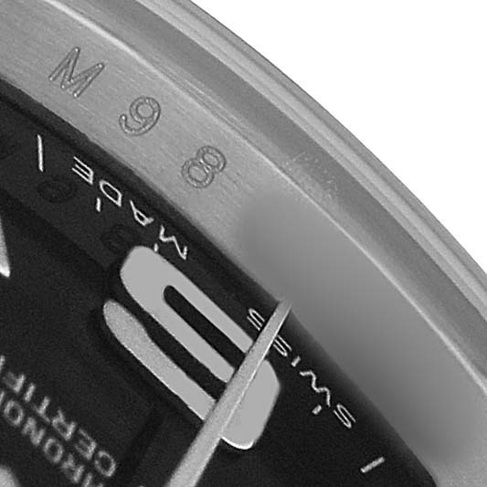 The image shows a close-up of the dial and edge of a Rolex Oyster Perpetual 176210 Women's Stainless Steel Black Dial, focusing on the serial number and "Swiss Made" text.