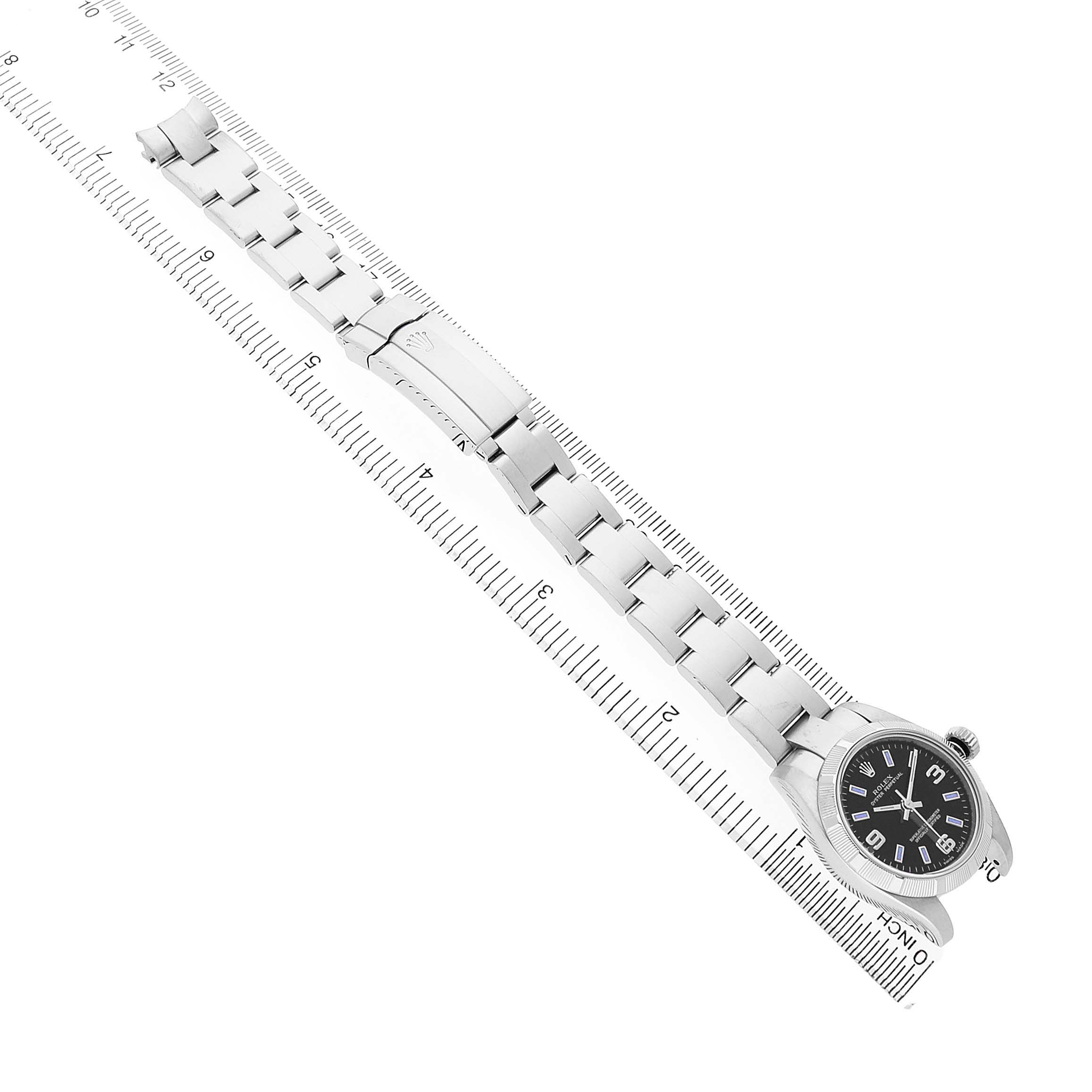 The Rolex Oyster Perpetual 176210 Women's Stainless Steel Black Dial watch is shown flat from the top, with its bracelet and face aligned along a ruler for measurement.
