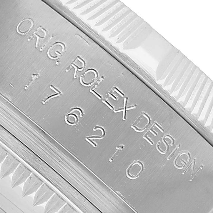 The image shows an angled close-up of the engraved bezel from a Rolex Oyster Perpetual 176210 Women's Stainless Steel Black Dial watch.