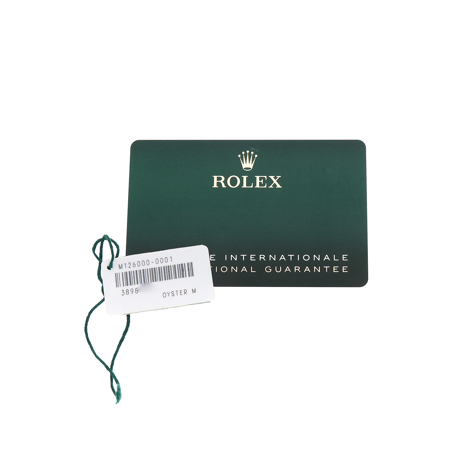 The image shows a Rolex Oyster Perpetual M126000-0001 Men's Stainless Steel Silver Dial model's guarantee card and a tag with a string, viewed from above.
