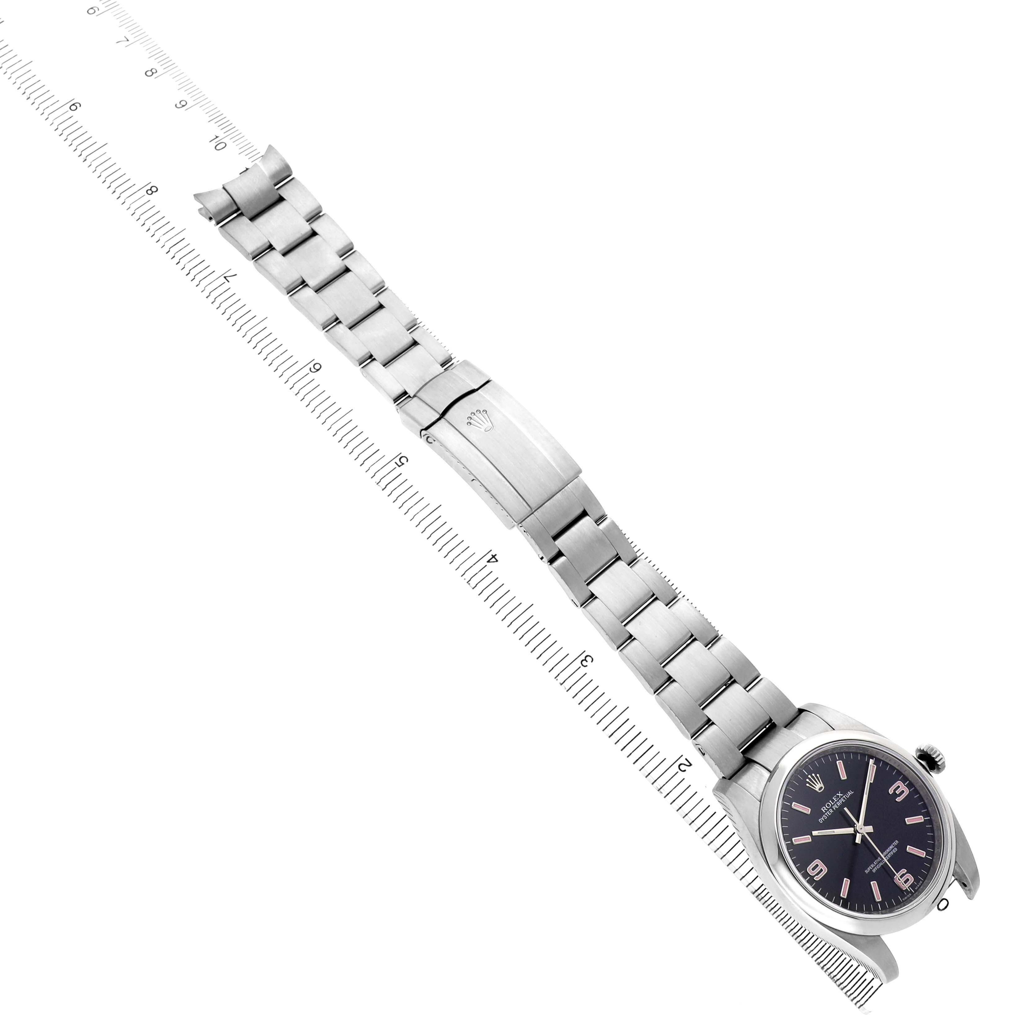 The Rolex Oyster Perpetual 116000 Men's Stainless Steel Black Dial watch is shown diagonally with the entire bracelet and clasp visible.