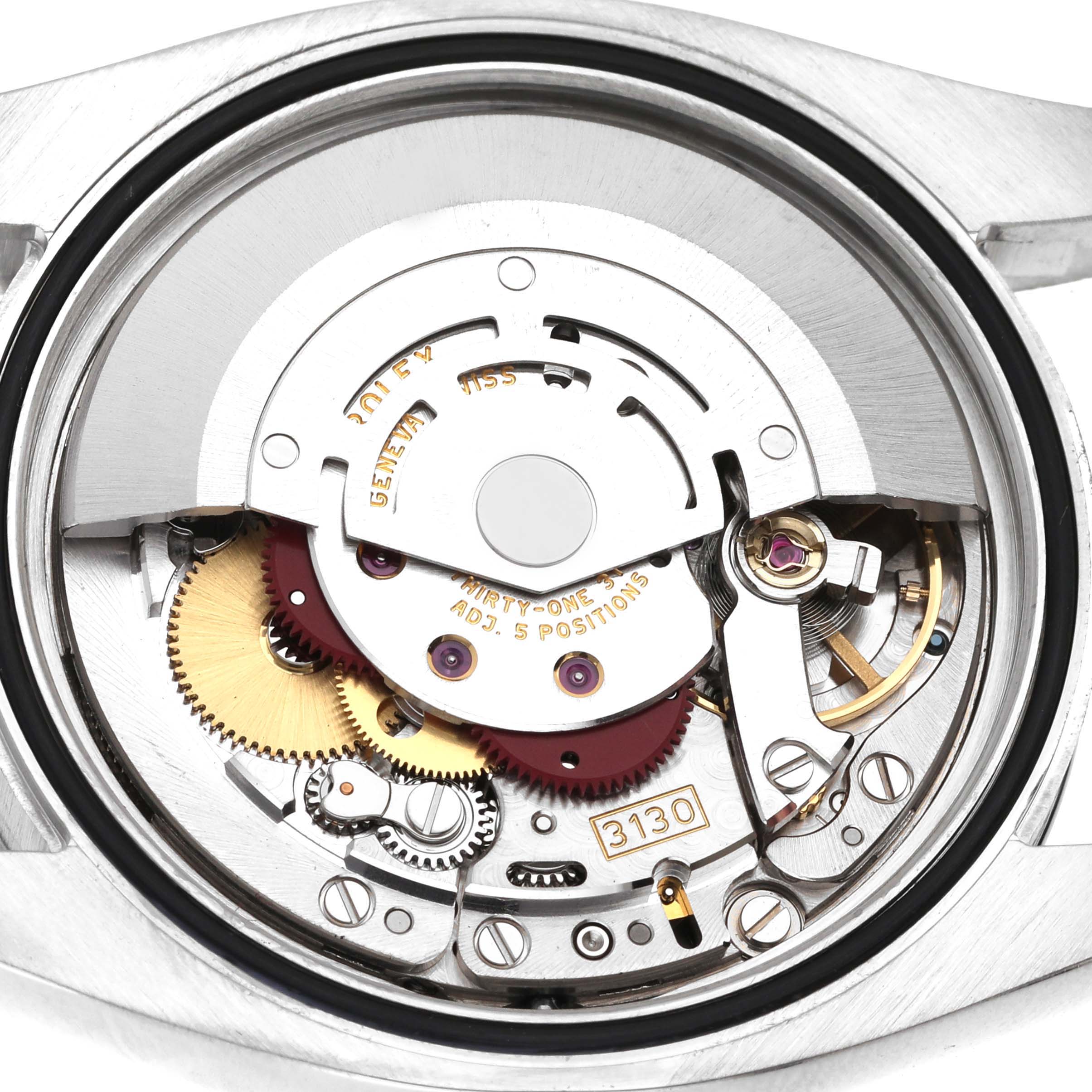 The image shows the internal components and automatic movement of a Rolex Oyster Perpetual 116000 Men's Stainless Steel Blue Dial 116000 Men's Stainless Steel Blue Dial watch from a rear angle.