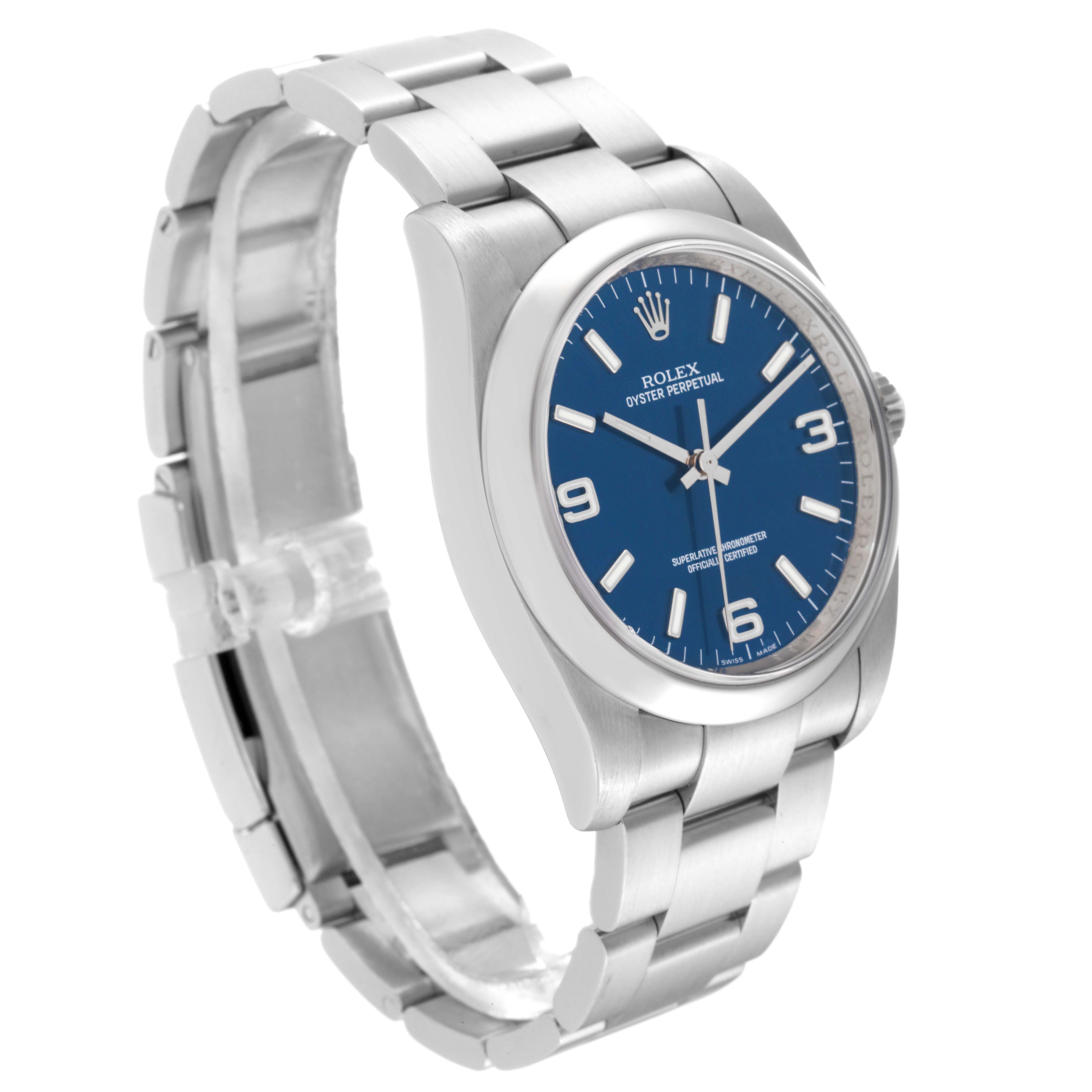 The image shows a side angle view of a Rolex Oyster Perpetual 116000 Men's Stainless Steel Blue Dial 116000 Men's Stainless Steel Blue Dial watch, highlighting its blue dial, silver markers, and stainless steel bracelet.