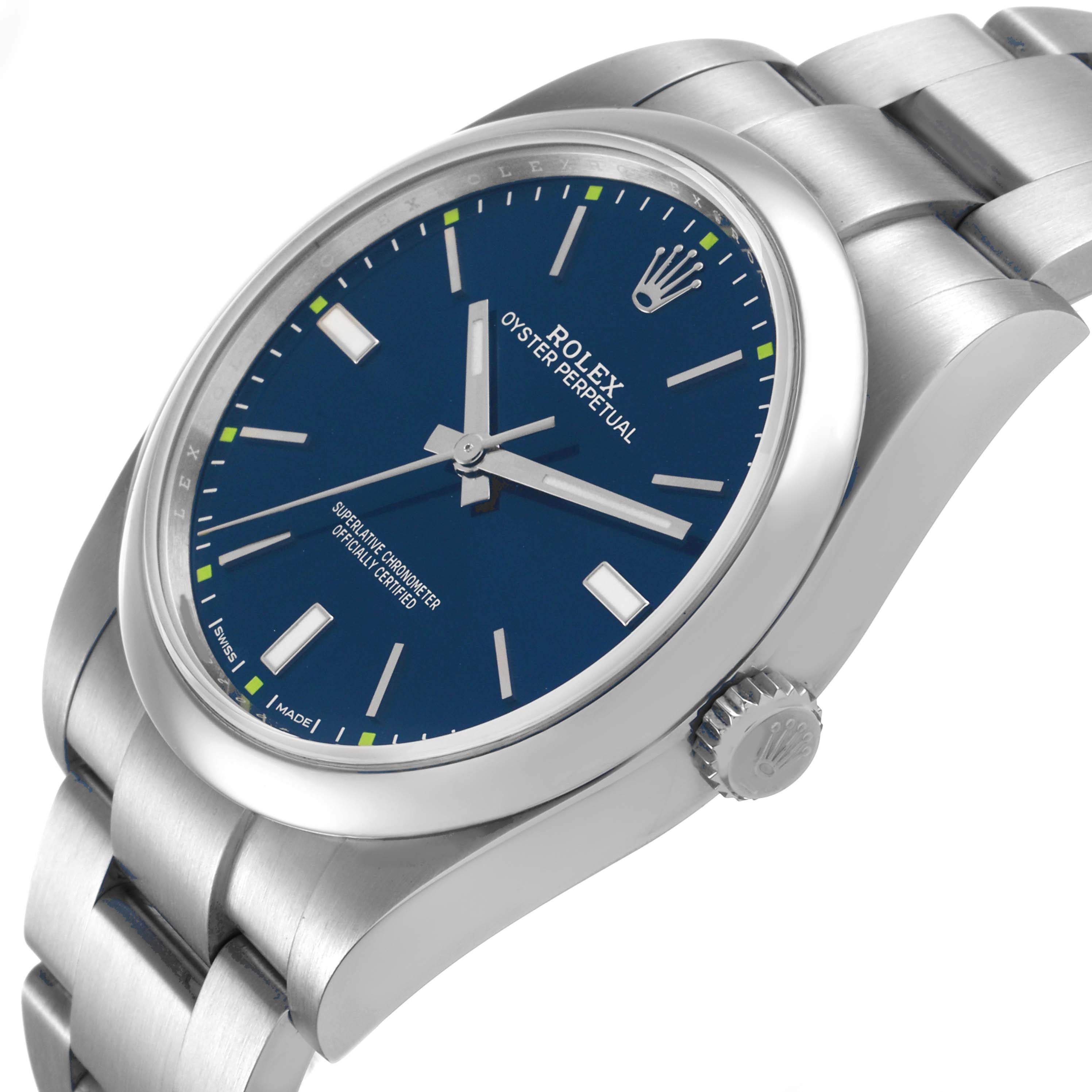 The Rolex Oyster Perpetual 114300 Men's Stainless Steel Blue Dial watch is shown at an angle highlighting the dial, bezel, case, crown, and bracelet links.