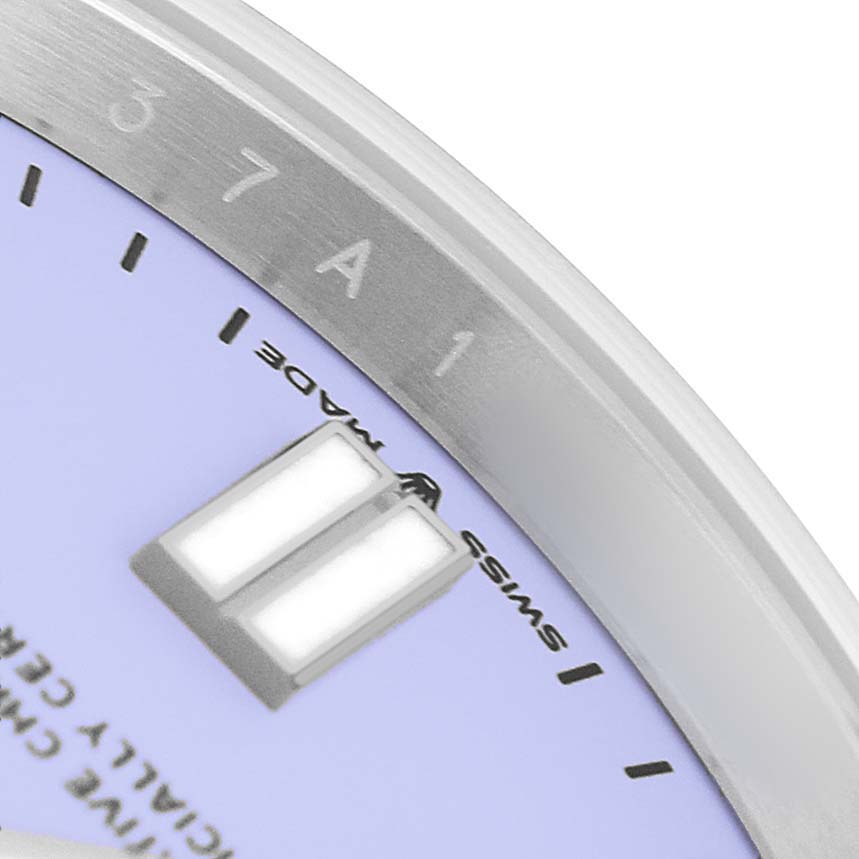 The image shows a close-up of the dial edge and hour markers of a Rolex Oyster Perpetual 134300 Men's Stainless Steel Purple Dial watch.