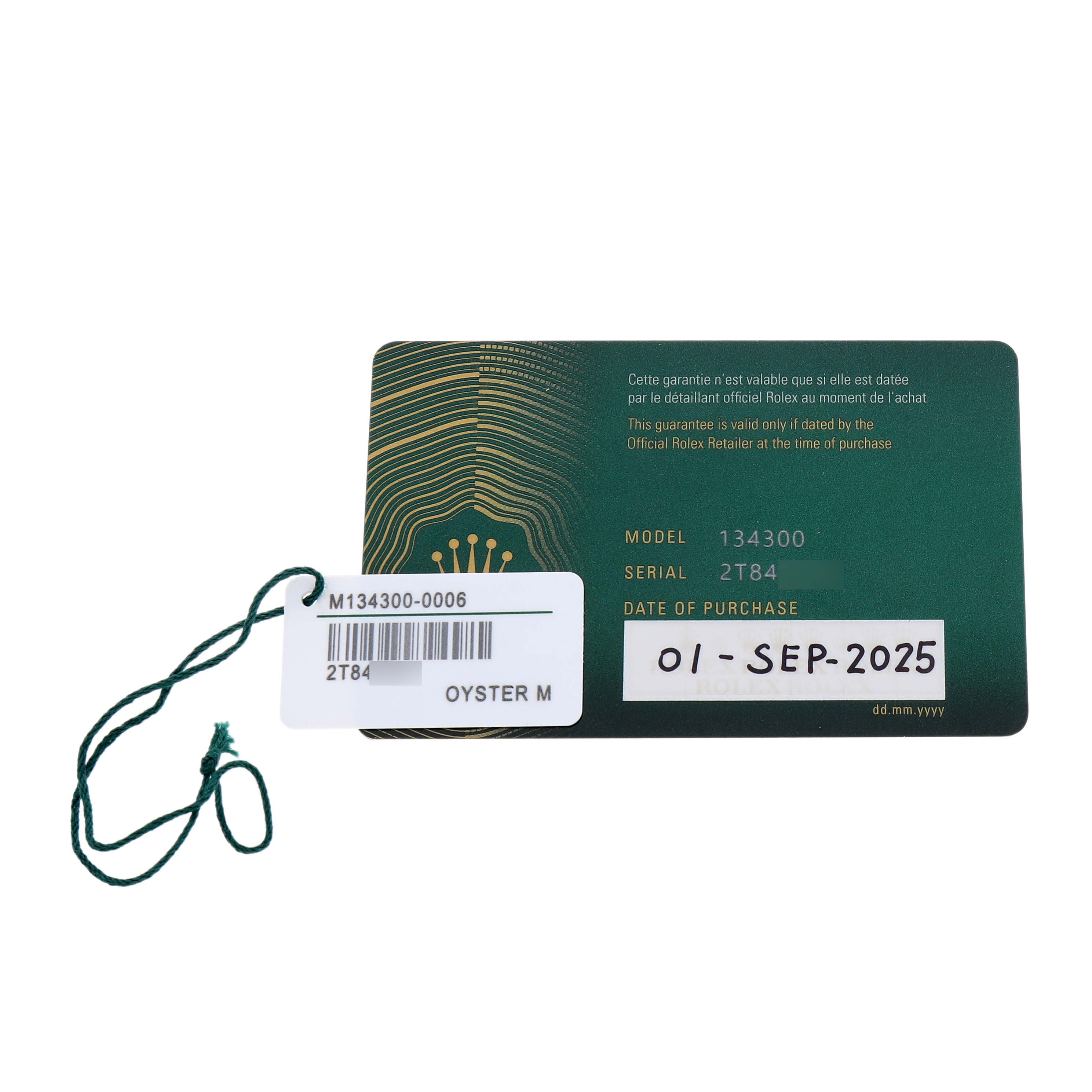 The image shows a Rolex Oyster Perpetual 134300 Men's Stainless Steel Green Dial warranty card with model and serial numbers, alongside a green tag with details.