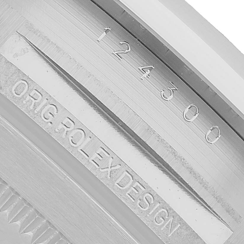 The image shows the inner engraving on the case of a Rolex Oyster Perpetual 124300 Men's Stainless Steel Silver Dial, highlighting the model number and "ORIG. ROLEX DESIGN."