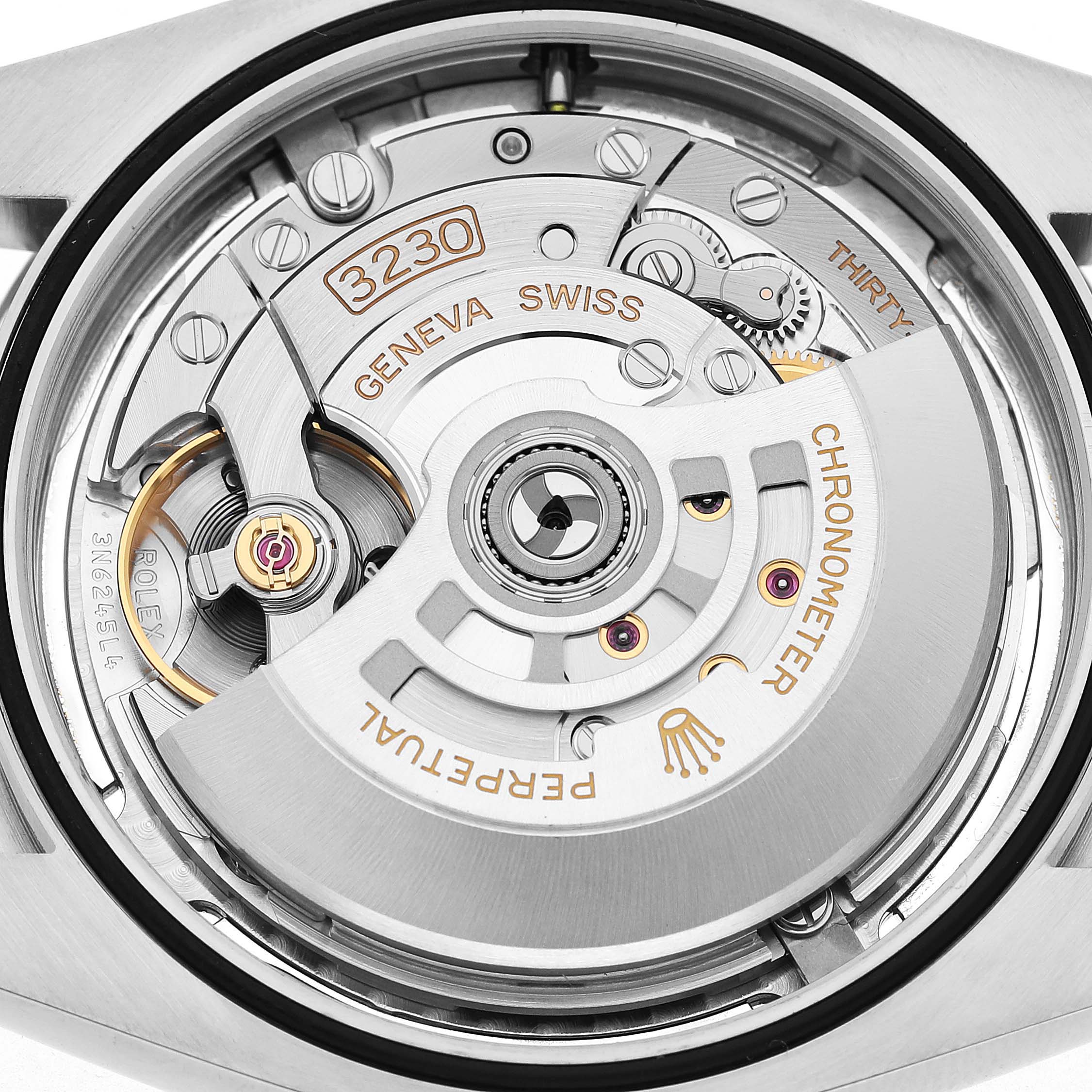 The image shows the movement of a Rolex Oyster Perpetual 124300 Men's Stainless Steel Silver Dial watch from the back, displaying its intricate internal components.