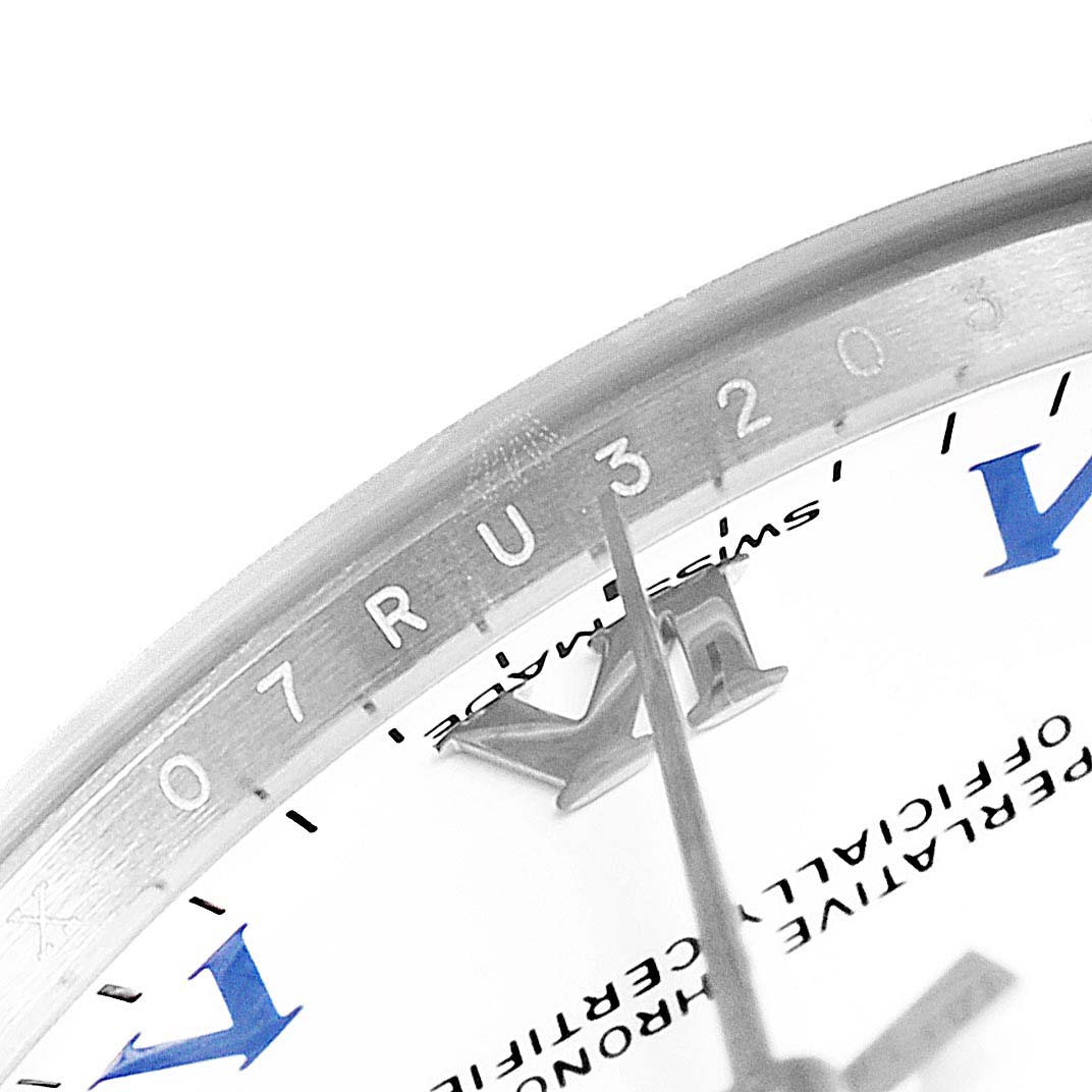 This close-up image shows a segment of the dial and bezel with part of the hand of the Rolex Mid-Size 177200  Women
s Stainless Steel White Dial 177200  Women
s Stainless Steel White Dial model watch.