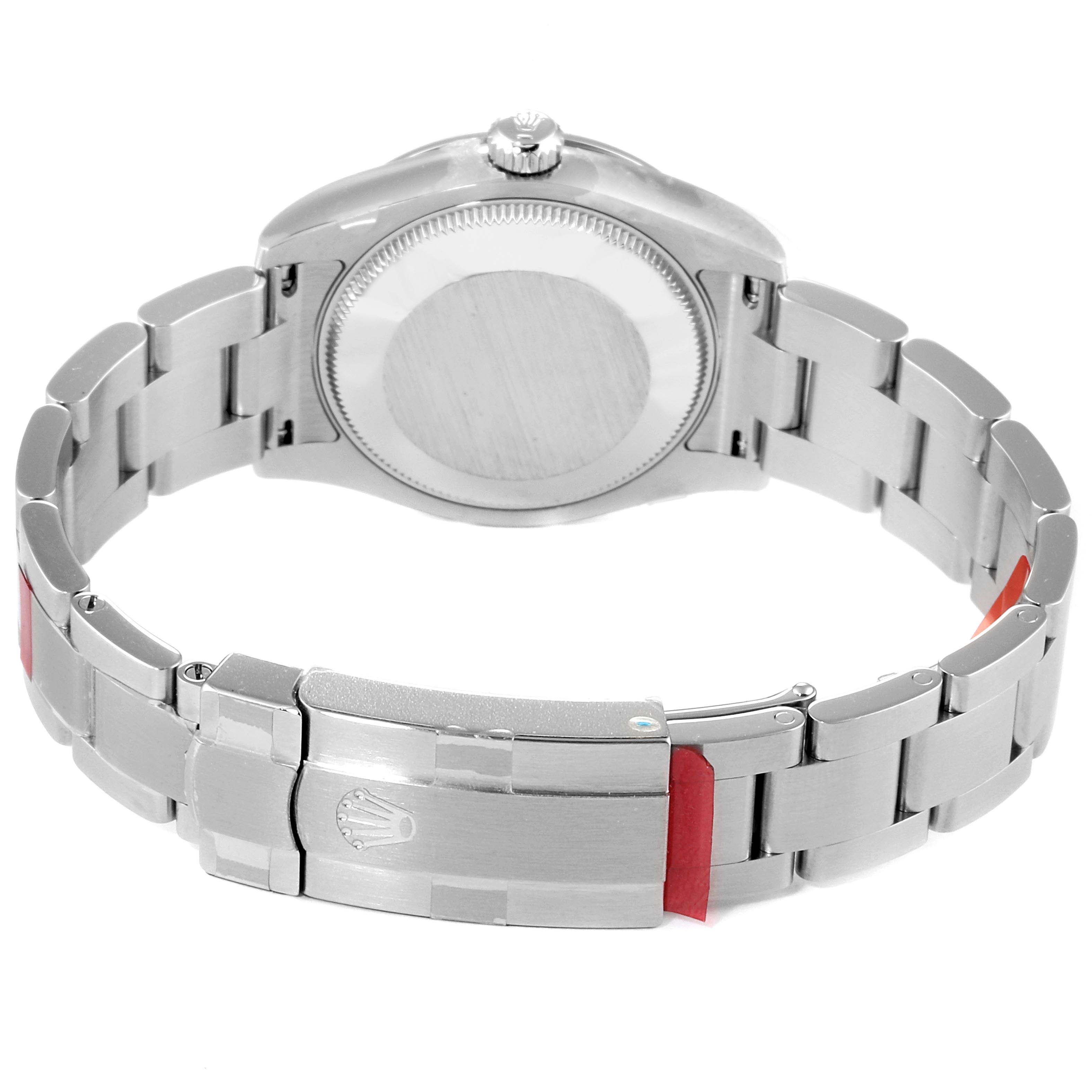 The image shows the back side and bracelet of a Mid-Size Rolex watch at an angle displaying the clasp and case back.