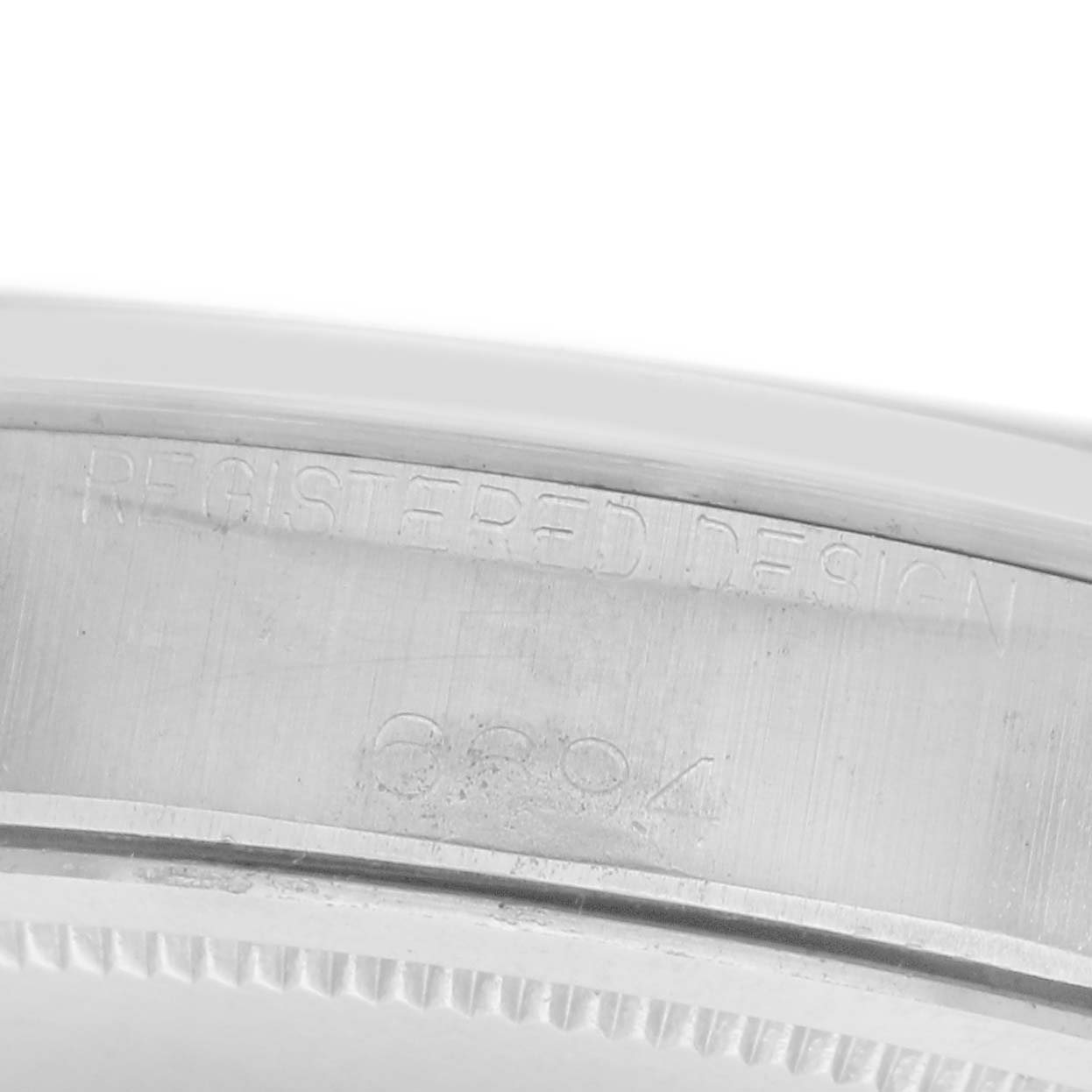 The image shows a close-up of the side of a Rolex Vintage Collection 6694 Men
s Stainless Steel Blue Dial 6694 Men
s Stainless Steel Blue Dial model, highlighting engraving details.