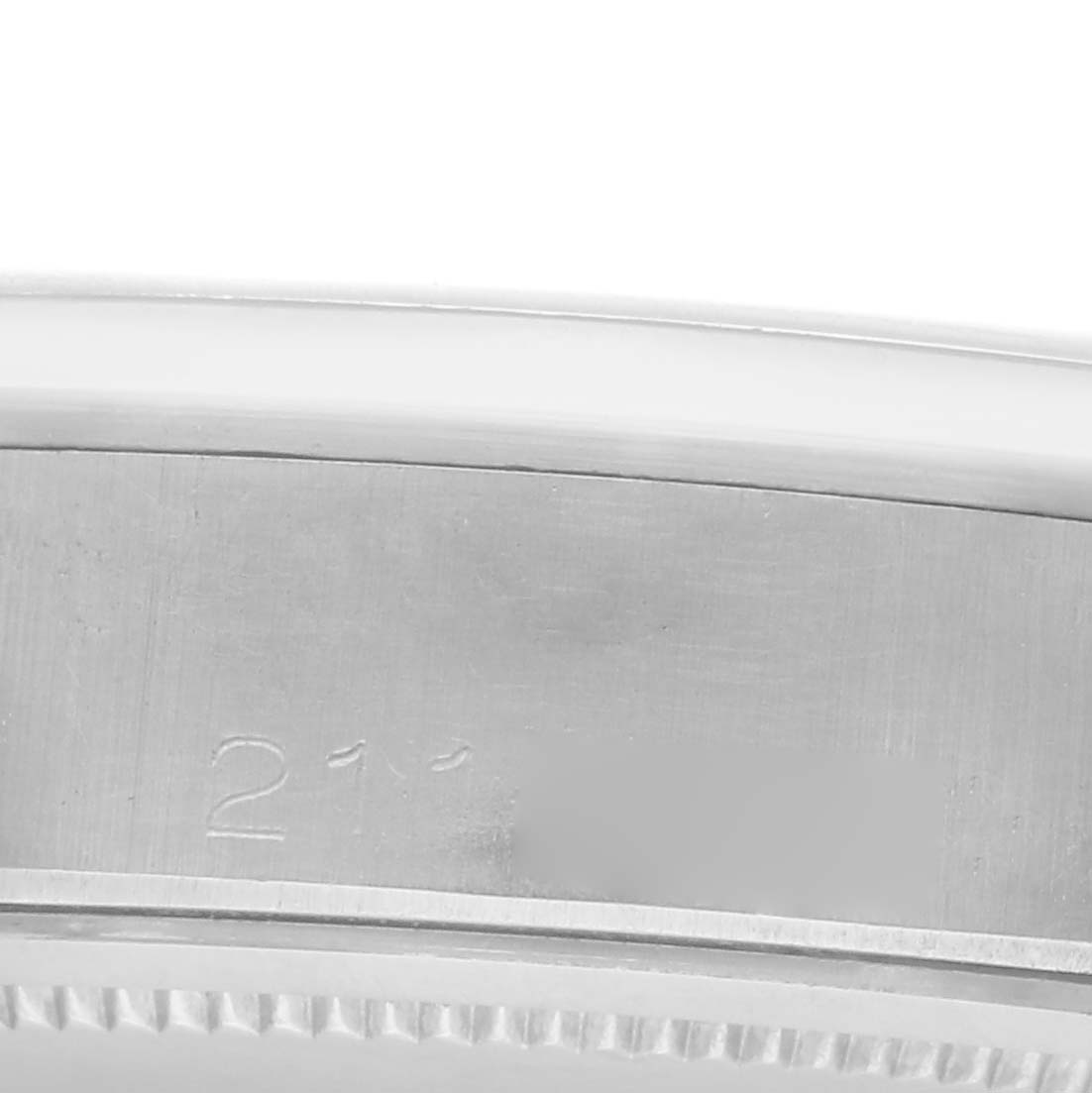 The image shows a close-up of the side of a Rolex Vintage Collection 6694 Men
s Stainless Steel Blue Dial 6694 Men
s Stainless Steel Blue Dial watch case, with visible engravings.