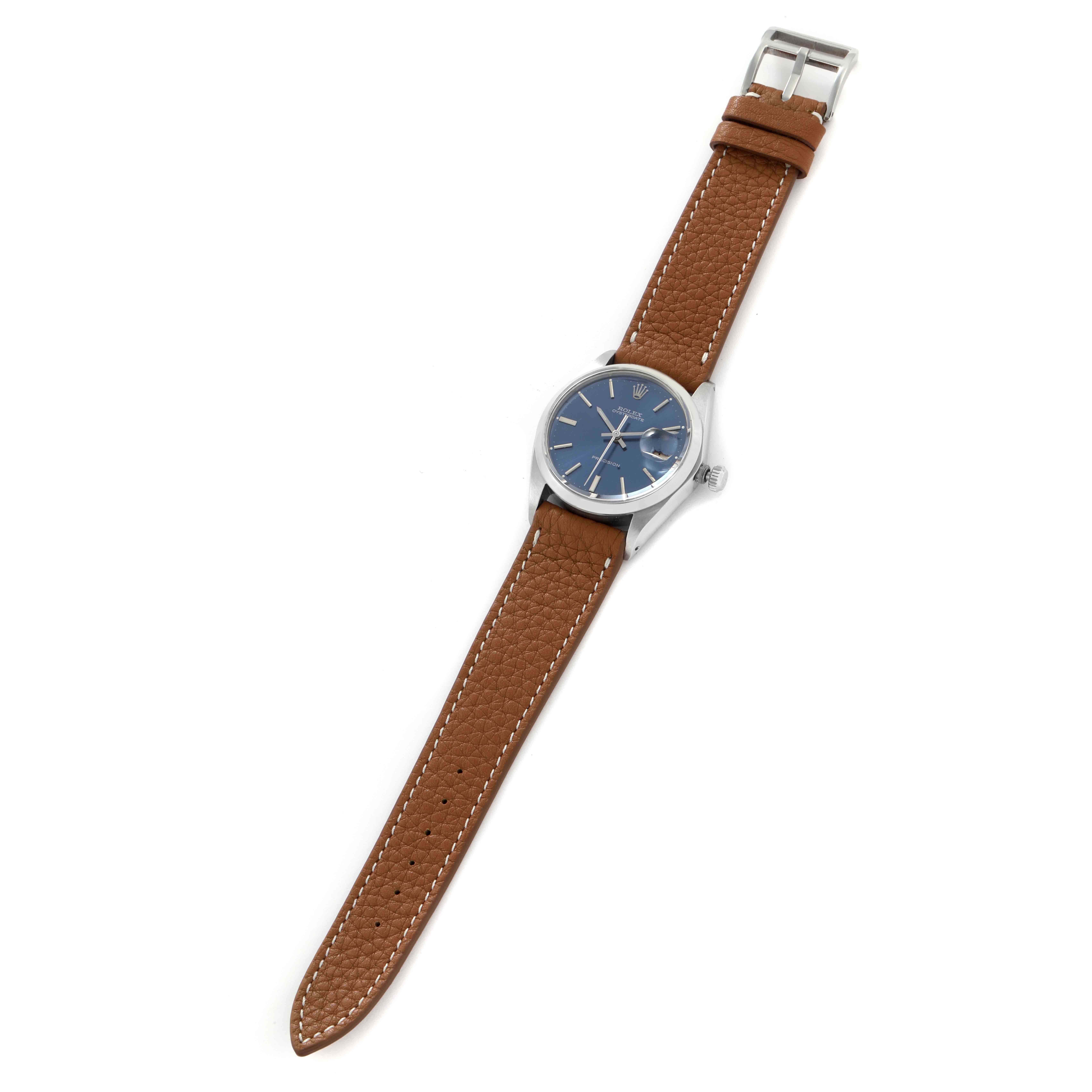 The Rolex Vintage Collection 6694 Men
s Stainless Steel Blue Dial 6694 Men
s Stainless Steel Blue Dial watch is shown from a top-down angle, featuring a blue dial and brown leather strap.