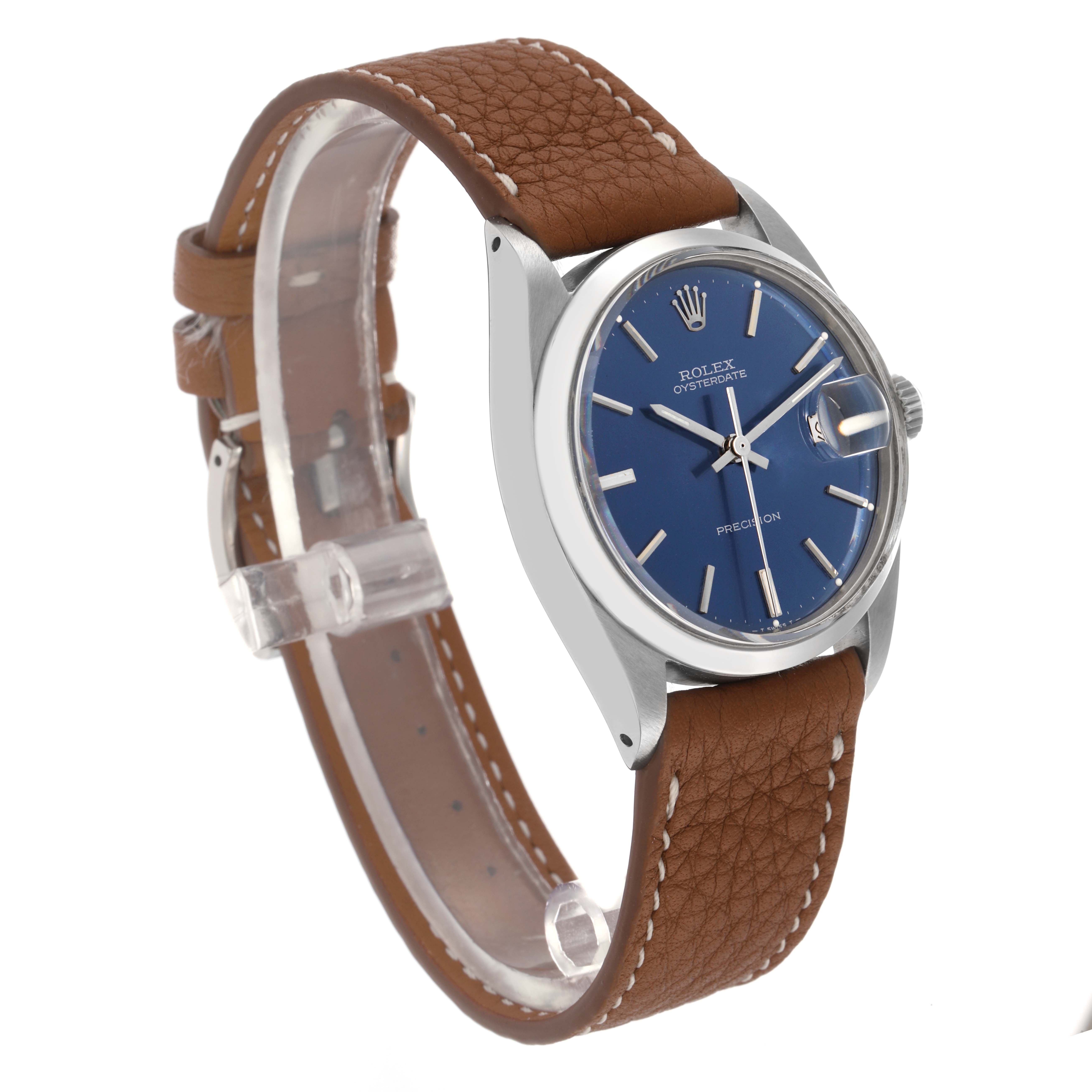 The Rolex Vintage Collection 6694 Men
s Stainless Steel Blue Dial 6694 Men
s Stainless Steel Blue Dial watch is shown from an angled side view, highlighting the blue dial, silver casing, and brown leather strap.