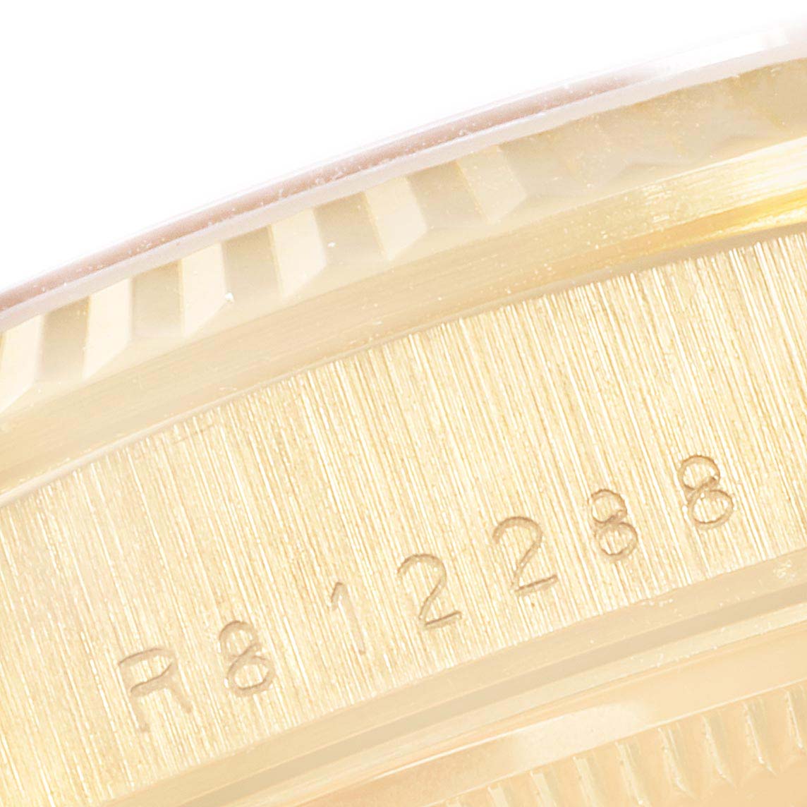 This is a close-up angle showing the engraved serial number on the gold case of a Rolex President 18238 Men's Yellow Gold Champagne Dial 18238 Men's Yellow Gold Champagne Dial model watch.