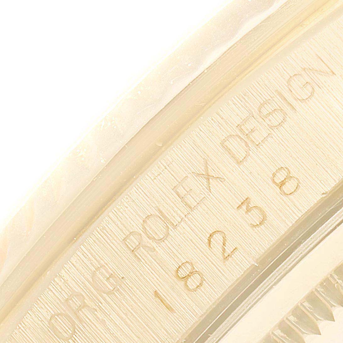 This close-up image shows part of the inner bezel of a Rolex President 18238 Men's Yellow Gold Champagne Dial 18238 Men's Yellow Gold Champagne Dial model watch, featuring engraved text and serial numbers.
