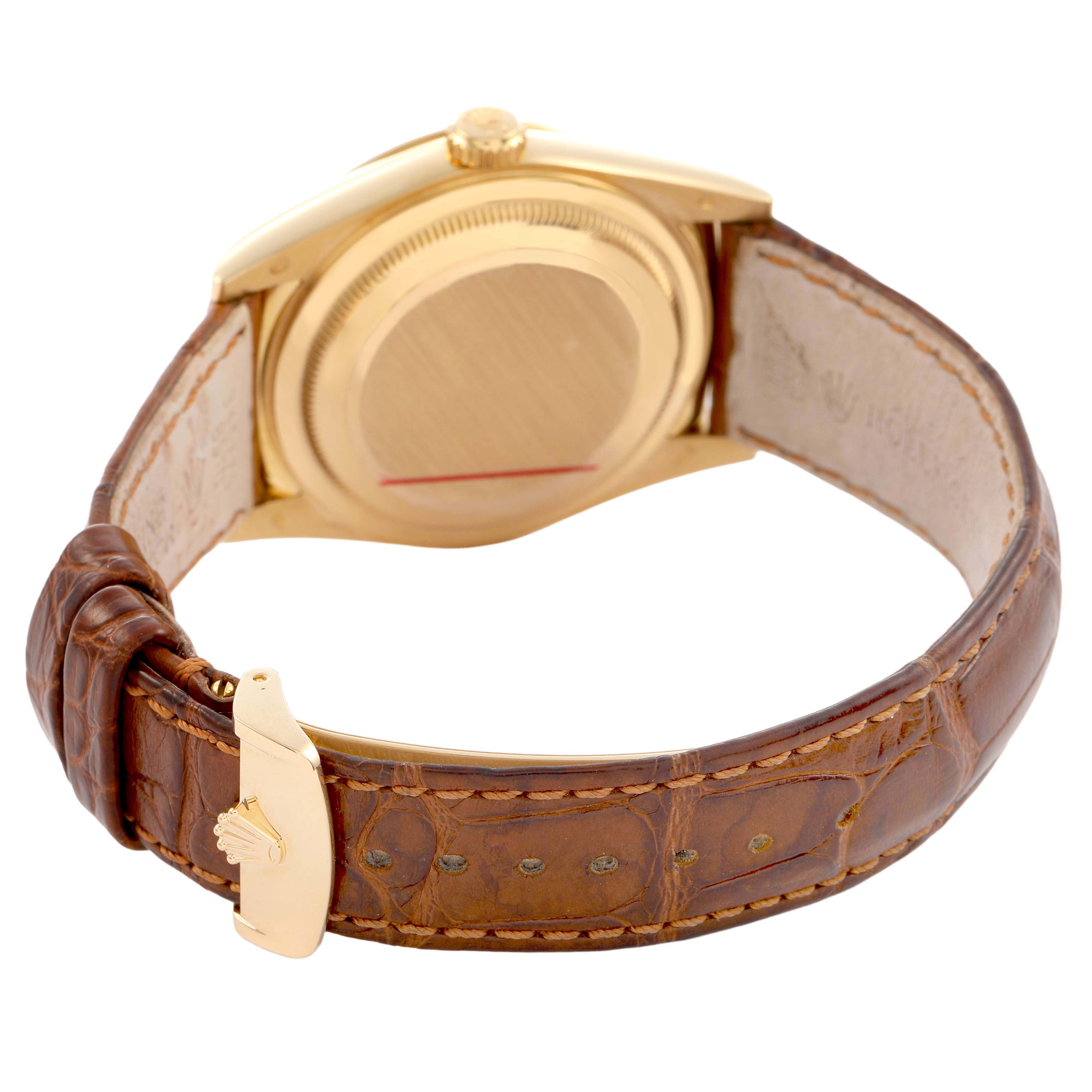 The image shows the back view of a Rolex President 118138 Men's Yellow Gold Orange Dial model, highlighting the case, crown, and leather strap with a clasp.