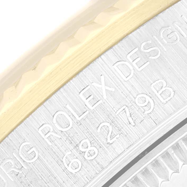 This close-up angle shows the engraved edge and part of the bezel of a Rolex President 68279 Women's White Gold Brown Dial 68279 Women's White Gold Brown Dial model watch.