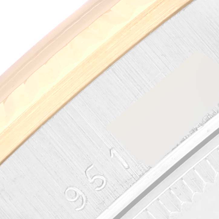 This close-up image of a Rolex President 68279 Women's White Gold Brown Dial 68279 Women's White Gold Brown Dial watch shows part of the bezel and outer edge, featuring some engraved numbers.