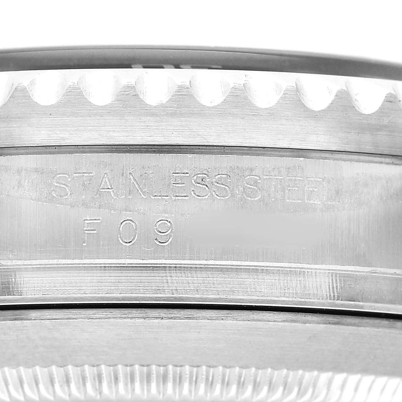 The image shows a close-up of the case side and part of the bezel of a Rolex Sea-Dweller 16600 Men's Stainless Steel Black Dial, highlighting the "Stainless Steel F09" engraving.