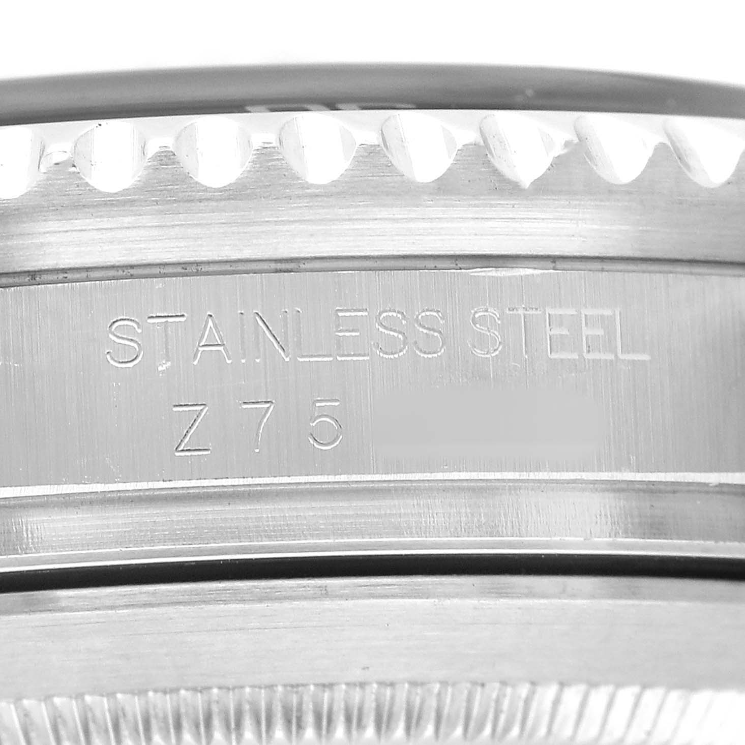 The image shows a close-up of the case back and edge of the bezel of the Rolex Sea-Dweller 16600 Men's Stainless Steel Black Dial, highlighting the "STAINLESS STEEL" engraving.