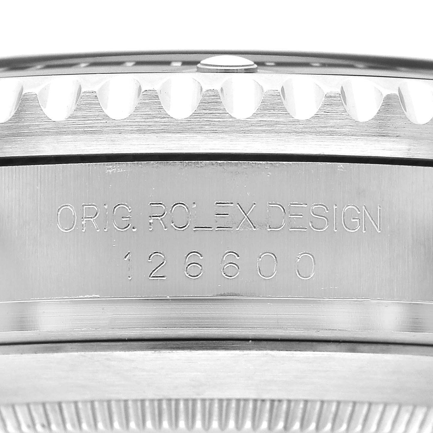 The image shows a close-up of the Rolex Sea-Dweller 126600 Men's Stainless Steel Black Dial model 126600, highlighting the engraved "ORIG ROLEX DESIGN" and model number on the watch case side.